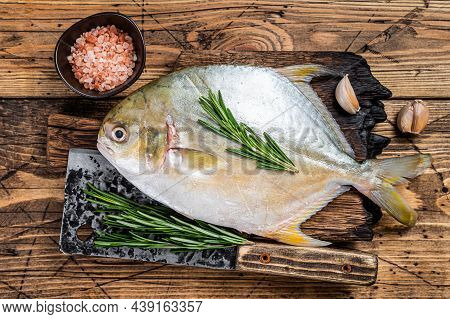 Raw Fish Sunfish Or Pompano On A Wooden Board. Wooden Background. Top View