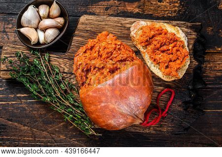 Sobrassada Cured Pork Meat Sausage On Bread Slice. Dark Wooden Background. Top View