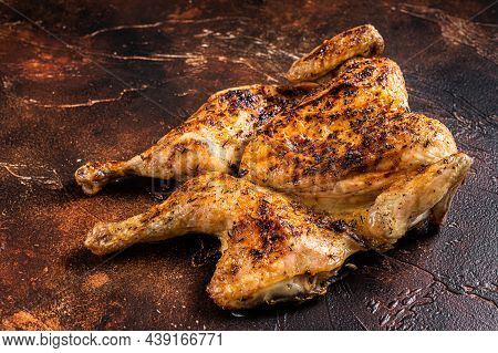 Whole Roasted Chicken Rotisserie With Herbs. Dark Background. Top View