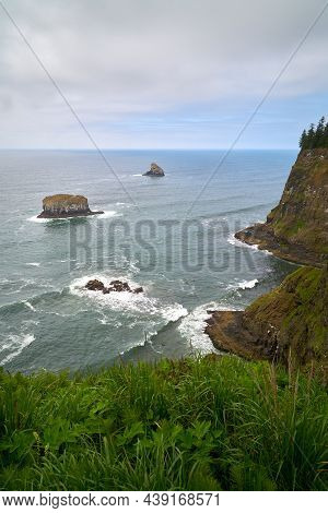Pillar Rock And Pyramid Rock Off Cape Meares Vertical. The View Of Pillar Rock And Pyramid Rock From