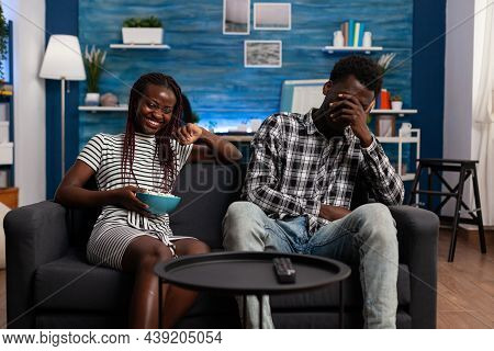 African American Partners Laughing And Having Fun At Home. Young Black Couple Smiling, Eating Popcor