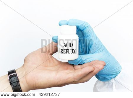 Acid Reflux Text On A White Jar With A Healer In The Hands Of A Doctor, Which Is Given To The Patien