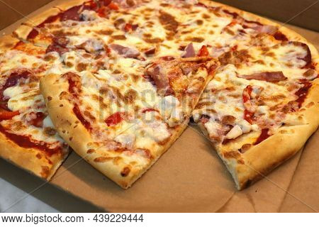 Pizza With Chicken Ham And Tomatoes. View From Above. Pizza Margaritta In A Cardboard Box