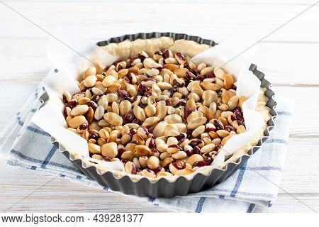 Round Shortcrust Pastry Case With Beans Ready For Blind Baking. Beans Used As Pastry Weights In An U