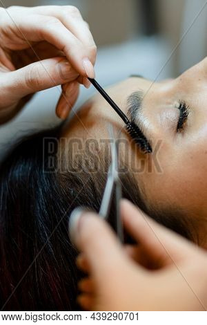 Customer getting eyebrow treatment at a beauty salon