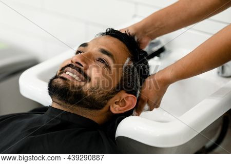 Man getting a hair wash at a barber shop