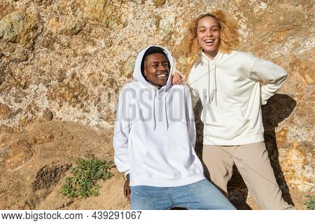 Happy couple in simple hoodies for winter outdoor shoot