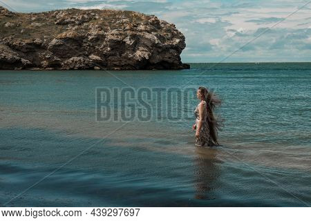 Girl With Long Hair Posing In Water. Treavel By The Sea
