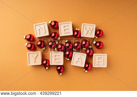 The Inscription New Year On Wooden Cubes. Wooden Cubes With Letters And Red Balls. Christmas Decorat