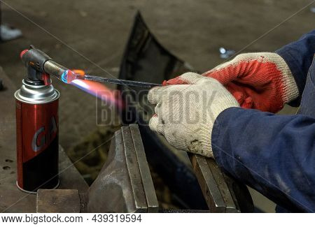 Worker Heats A Metal Tool With A Gas Gun To Create A New, Exclusive Shape.