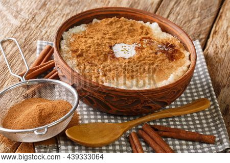 Cinnamon Rice Pudding Risengrod Close Up In The Bowl On The Table. Horizontal