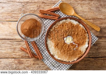 Traditional Danish Rice Pudding Risengrod Topped With Cinnamon, Sugar And Butter Close Up In The Bow