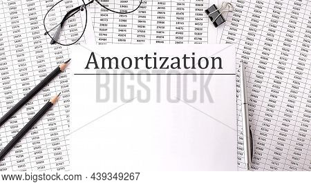 Paper With Amortization On Table With Chart And Pencils