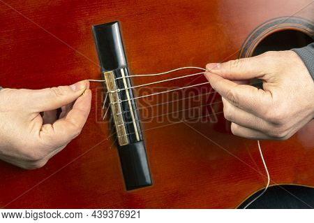 Replacement And Insertion Of Nylon Strings In A Classical Guitar. Lesson For A Musician