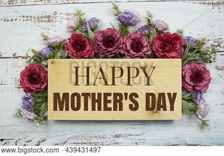 Happy Mother's Day Text With Flowers Frame Decprate On Wooden Background
