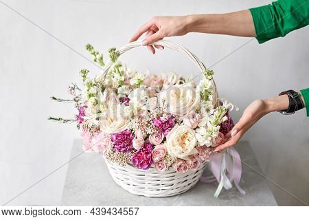 Flower Arrangement In Wicker Basket. Beautiful Bouquet Of Mixed Flowers In Woman Hand. Handsome Fres
