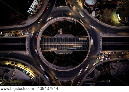 Aerial Drone Top View Of A Modern Designed Motorway Junction. Roundabout With Cars Moving. Transport