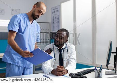 Medical Team Of Practitioners Analyzing Disease Symptoms Discussing Healthcare Treatment Working In 