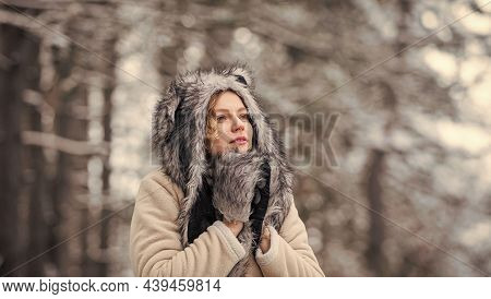Girl In Snowy Forest. Faux Fur Animal Hat Perfect For Fantasy Theme. Heartwarming Concept. Animal Ca