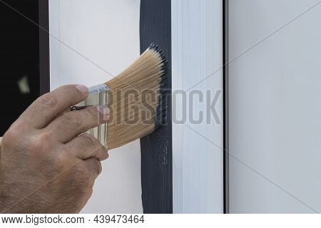 Close Up Of A Painter Cutting In The Edge Of A New Door.