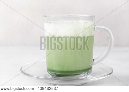 Matcha Latte With Foam On Plant-based Milk In Glass Cup On The White Table. Hot Healthy Vegan Drink