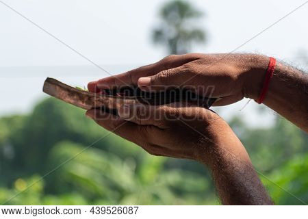 Image Of The Hands Of A Young Man- Praying In The Morning Holding Kosha Kushi.