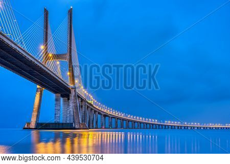 The Vasca Da Gama Bridge Across The River Tagus In Lisbon, Portugal, At Dusk