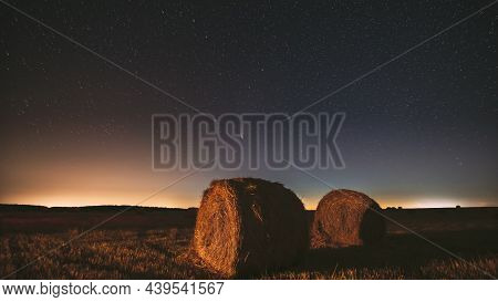 Comet Neowise C 2020 F3 In Night Starry Sky Above Haystacks In Summer Agricultural Field. Night Star