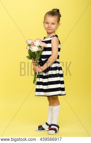 Cute Little Girl In Nice Dress With Bouquet Of Flowers. Half Turned Full Length Portrait Of Pretty L