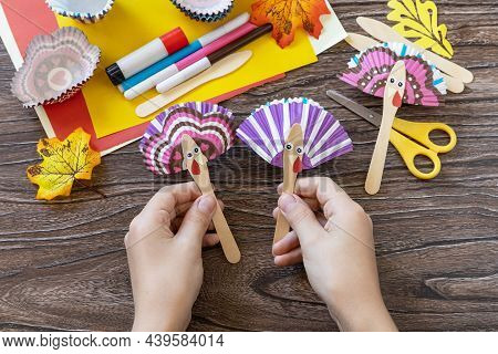 In The Hands Of A Child Craft Thanksgiving Toy Stics Puppets Turkey. Childrens Art Project, Handmade