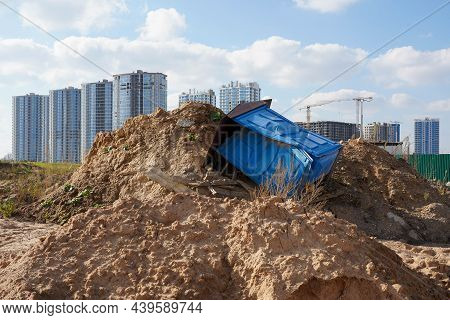 Photo Of A Broken Blue Dry Closet On The Ground At A Construction Site On The Street.
