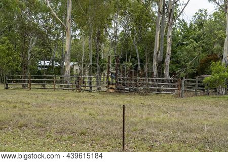 Wooden Fence Around Cattle Yards With Wagon Wheels As Decoration, Country Farm Homestead