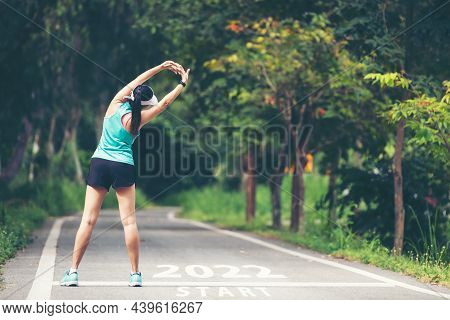 The Start Into The New Year 2022. Start Up Of Runner Woman Running On Nature Race Track Go To Goal O