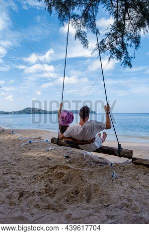 Bang Tao Beach Phuket Thailand, Beach With Palm Trees And A Couple Man And Women In The Swing On The
