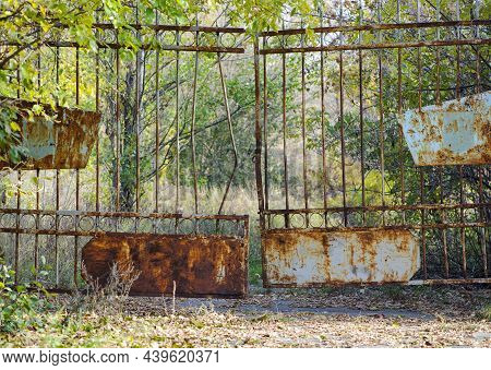 Old Rusty Iron Gate With A Deadbolt. Old Rusty Iron. Rusty Grungy Old Metal Texture For Use As A Bac