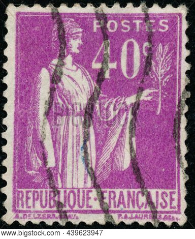 Vintage Stamp Printed In France Circa 1932 Shows Antique Character With Olive Branch