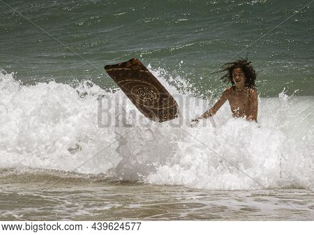 Honolulu, Hawaii - Nov 6, 2021-boy Loses Control Of His Boogey Board In The Surf.