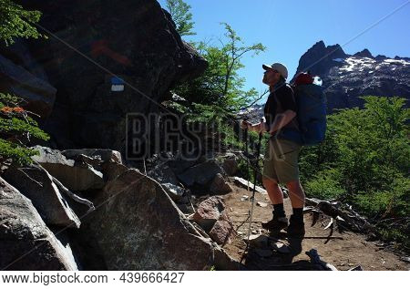 Man trekking with big backpack in Nahuel Huapi national park, Backpacker on hiking trail in Andes mountains of Patagonia, Argentina