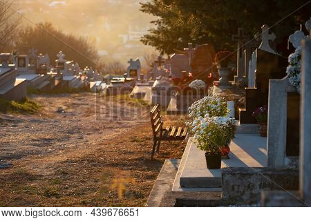 Headstones and grave sites in magic sunset at a cemtery