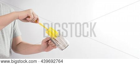 Clean And Wash Dish Concept. Man Hand Washing Drink Glass On White Background.