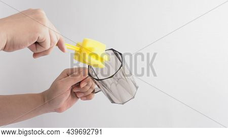 Clean And Wash Dish Concept. Man Hand Washing Drink Glass On White Background.