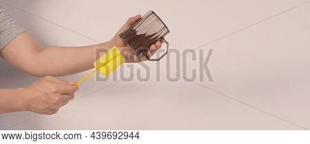 Clean And Wash Dish Concept. Man Hand Washing Drink Glass On White Background.