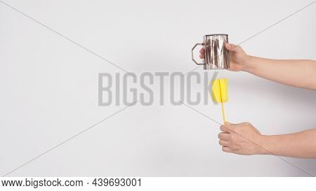 Clean And Wash Dish Concept. Man Hand Washing Drink Glass On White Background.