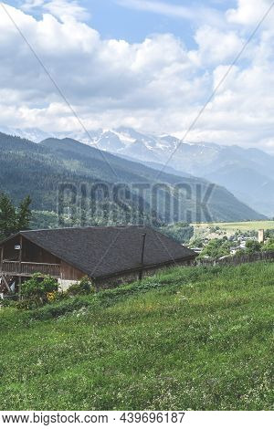 View Of Highland Townlet Mestia In Svaneti Region, Georgia. Green Meadows, Valles And Rural Houses. 