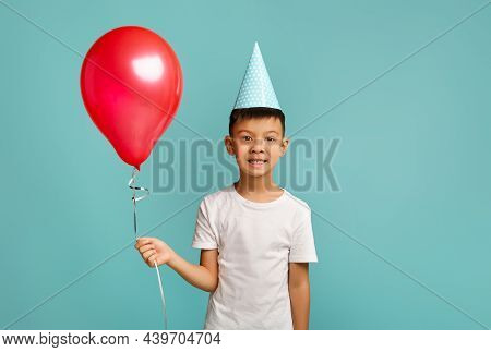 B-day Celebration. Portrait Of Excited Happy Little Asian Boy Holding Red Baloon
