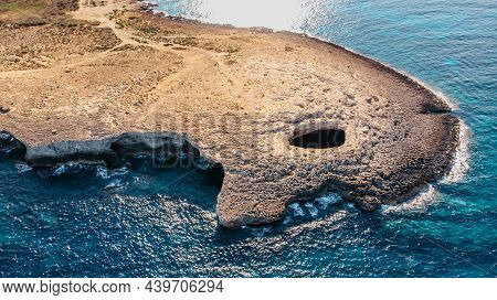 Aerial View Of Ahrax Fallen Cave,coral Lagoon,malta.hole In The Middle Of Rocks With Crystal Clear W