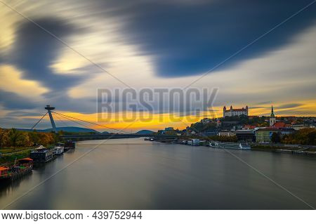 Sunset Over Bratislava Castle, Danube River And The Snp Bridge Also Called Ufo Bridge In Bratislava,
