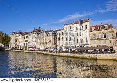 Bayonne, France - October 17, 2021: Historic Houses Reflected In The Nive River In Bayonne, France