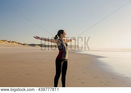Beautiful woman open her arms and relaxing after her exsercise