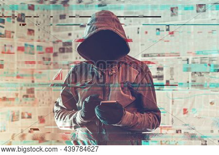 Hooded Hacker Person Using Smartphone In Infodemic Concept With Digital Glitch Effect